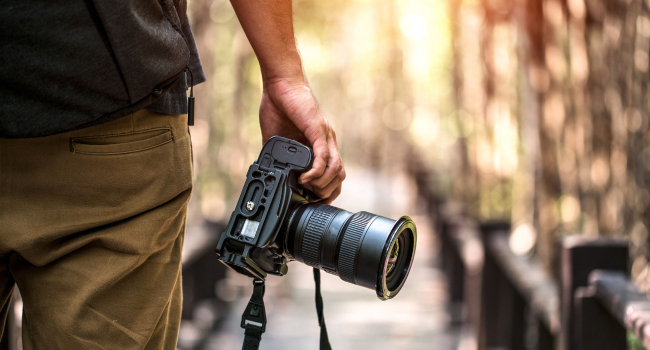 Image of A Professional Photographer With pro-Camera In His Hand - Professioanal Photography Concept.