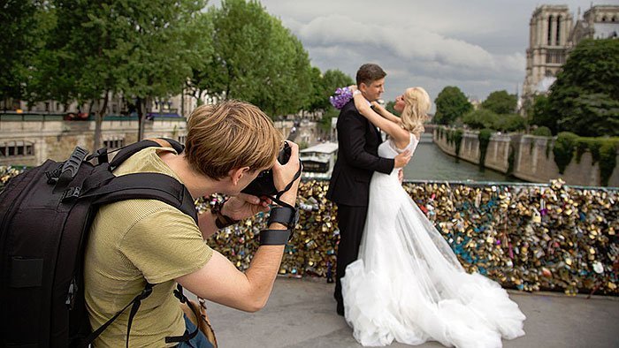  Image Showing A Wedding Photographer Photographing A Wedding Couple In A Floral Decoration Background.